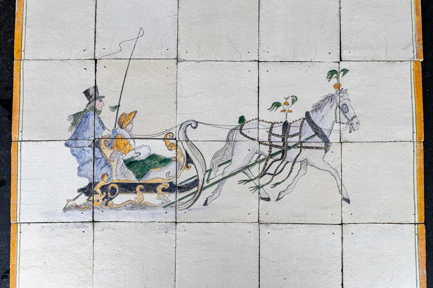 Antique tile panel with a yellow border and kiln marks