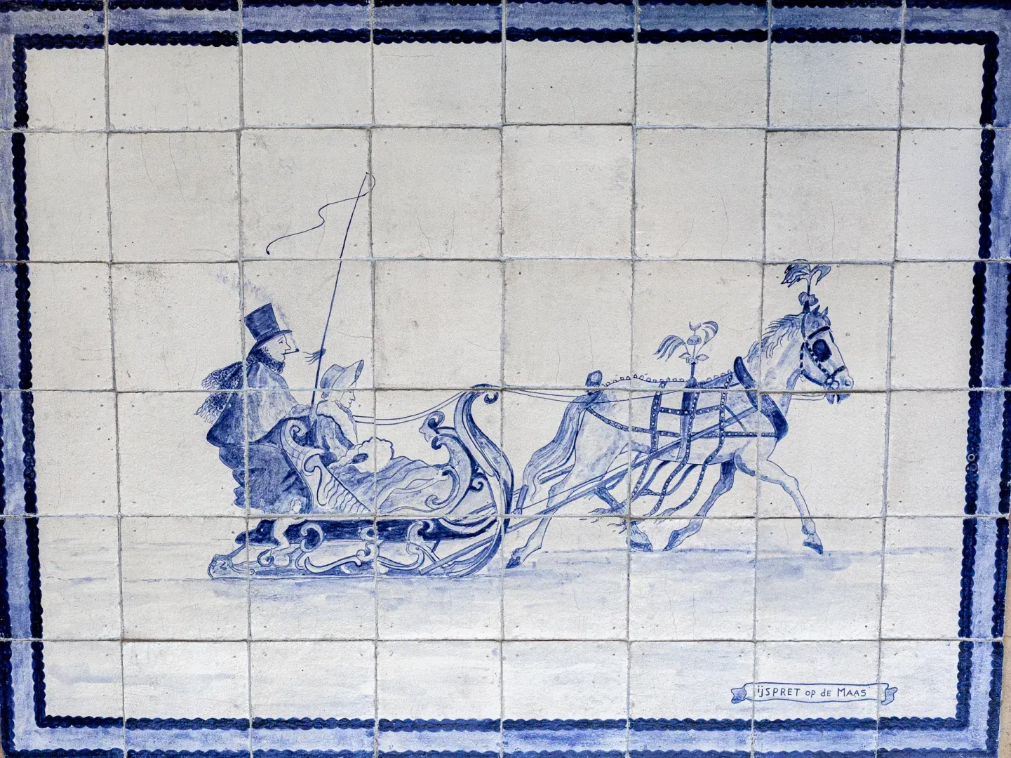 Antique Delft-blue tile panel depicting winter fun on the Meuse
