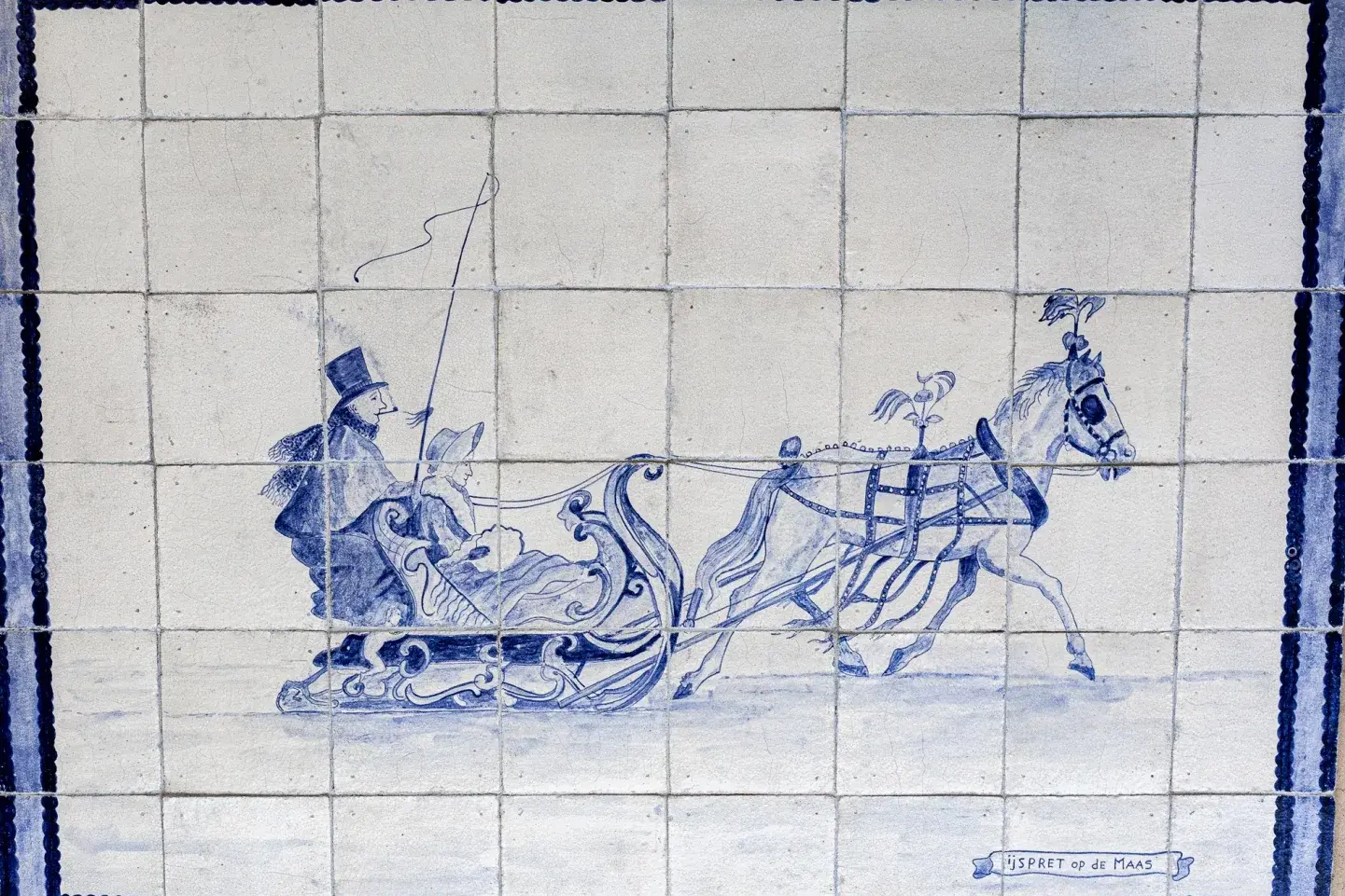 Antique Delft-blue tile panel depicting winter fun on the Meuse