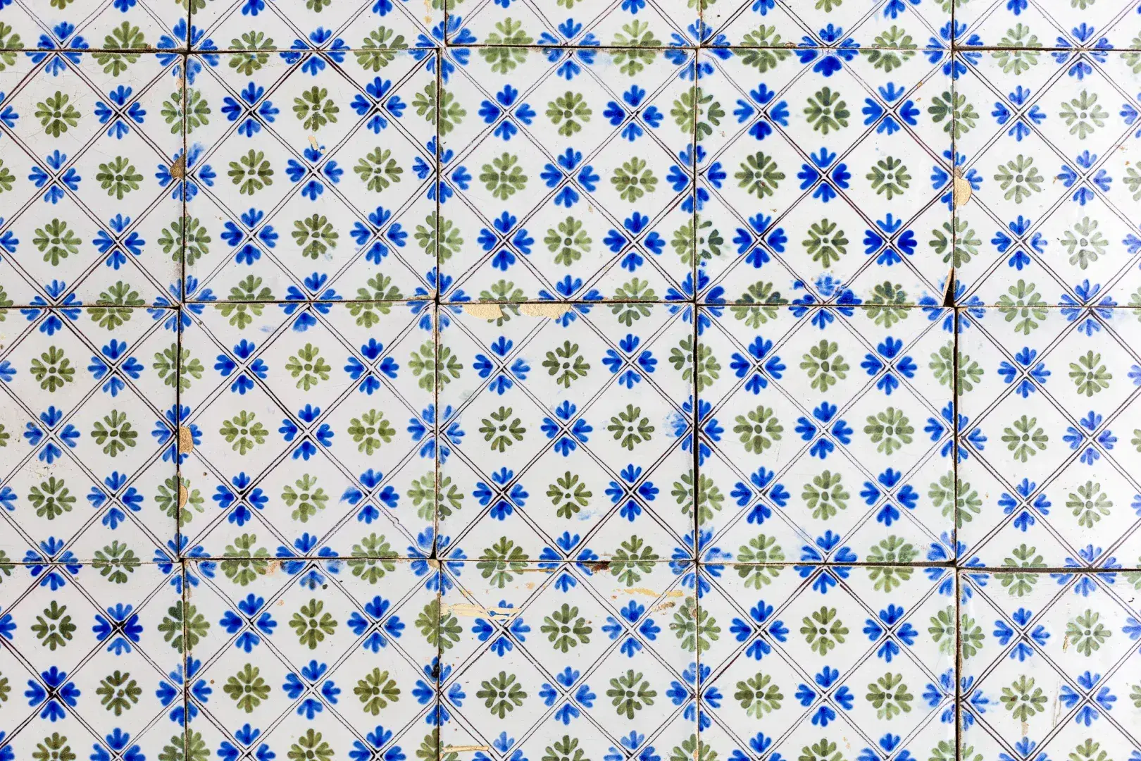 Antique painted wall tile with small flowers