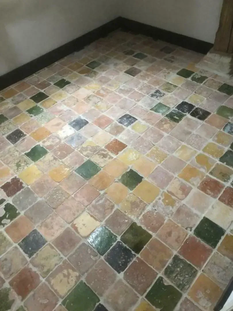 Antique glazed floor tiles in mixed colours