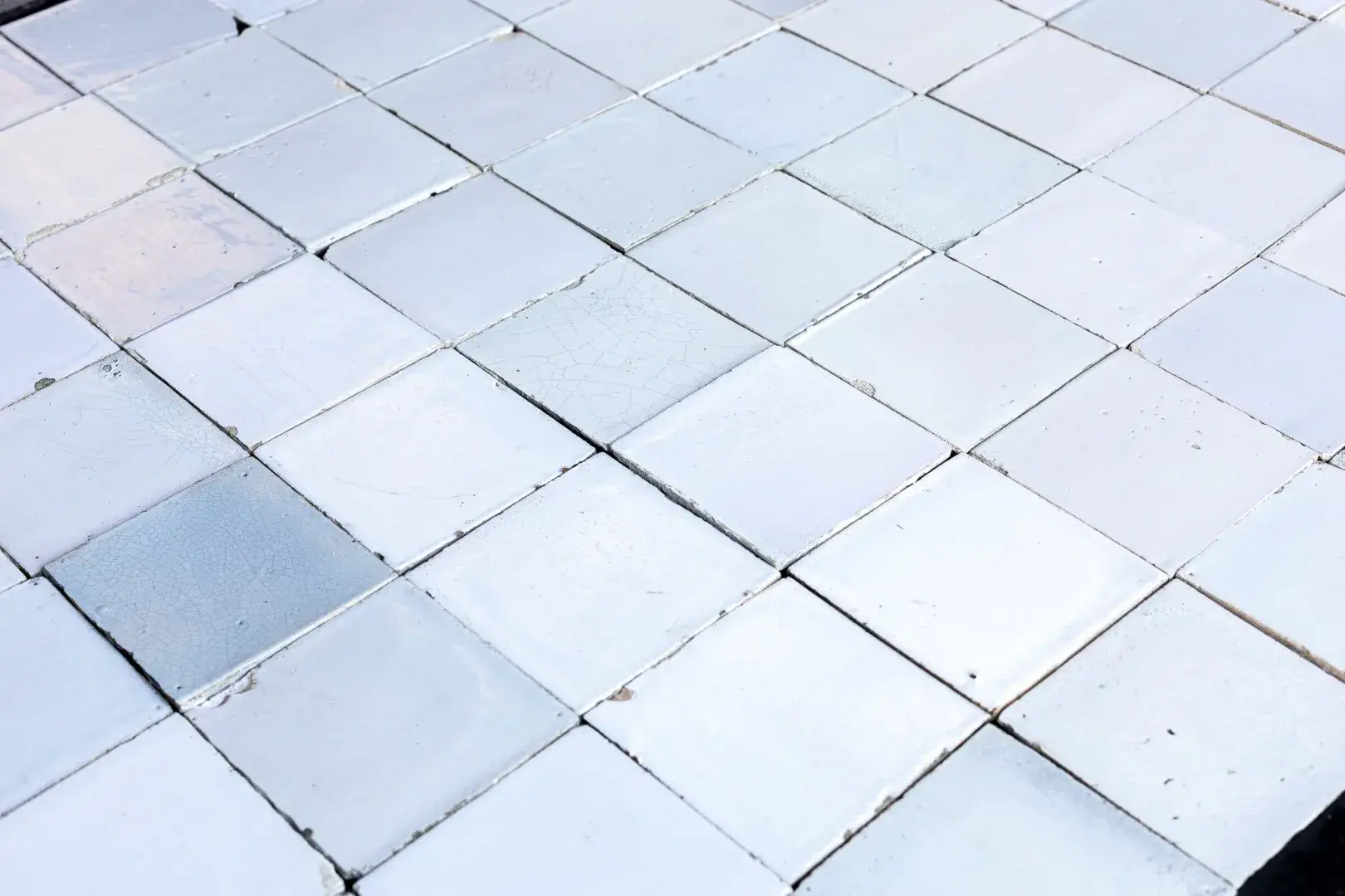 Authentic old handmade white tiles with subtle colour variations