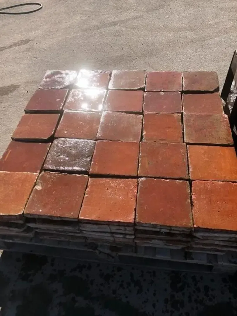 Old brown-glazed terracotta floor tiles