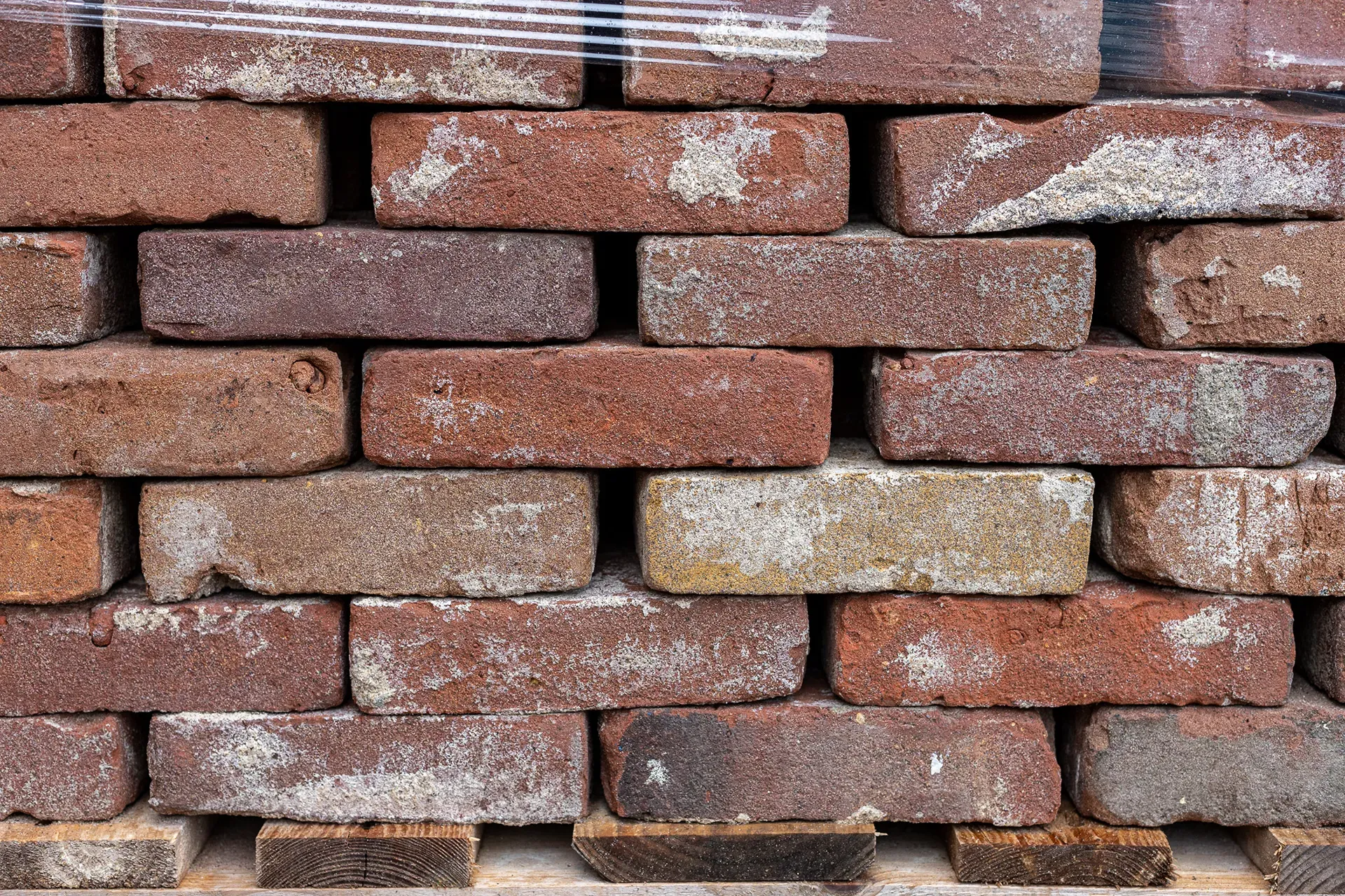 Antique dark-red facing bricks cleaned of mortar