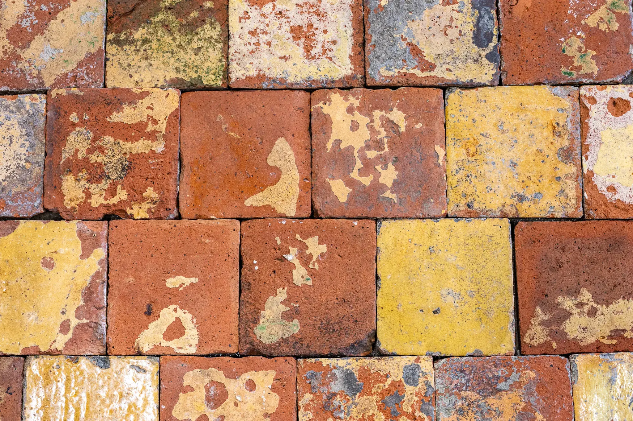 Antique yellow-glazed terracotta floor tiles