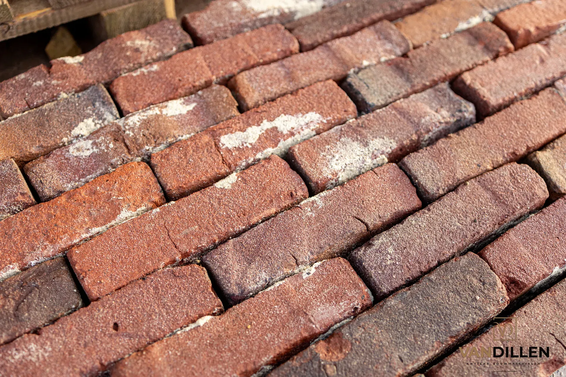 Antique dark purple-red bricks cleaned of mortar