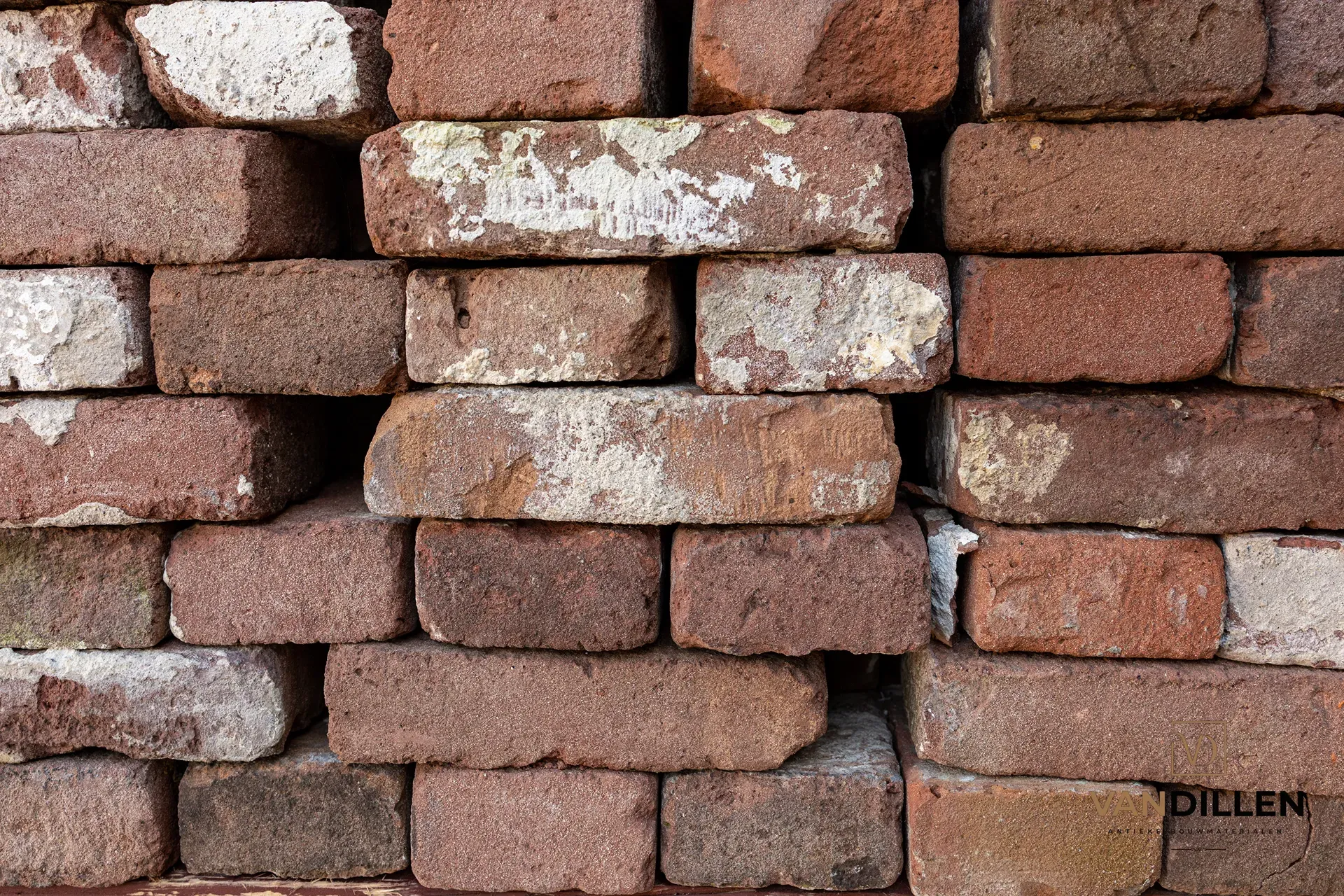 Dark-coloured old bricks cleaned of mortar