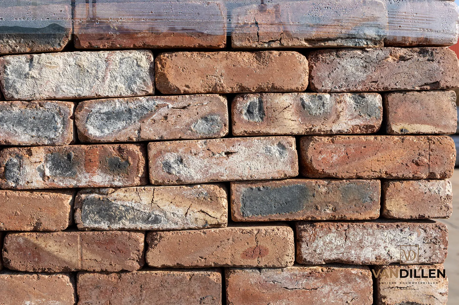 Old cleaned moulded bricks in varied brown-red tones