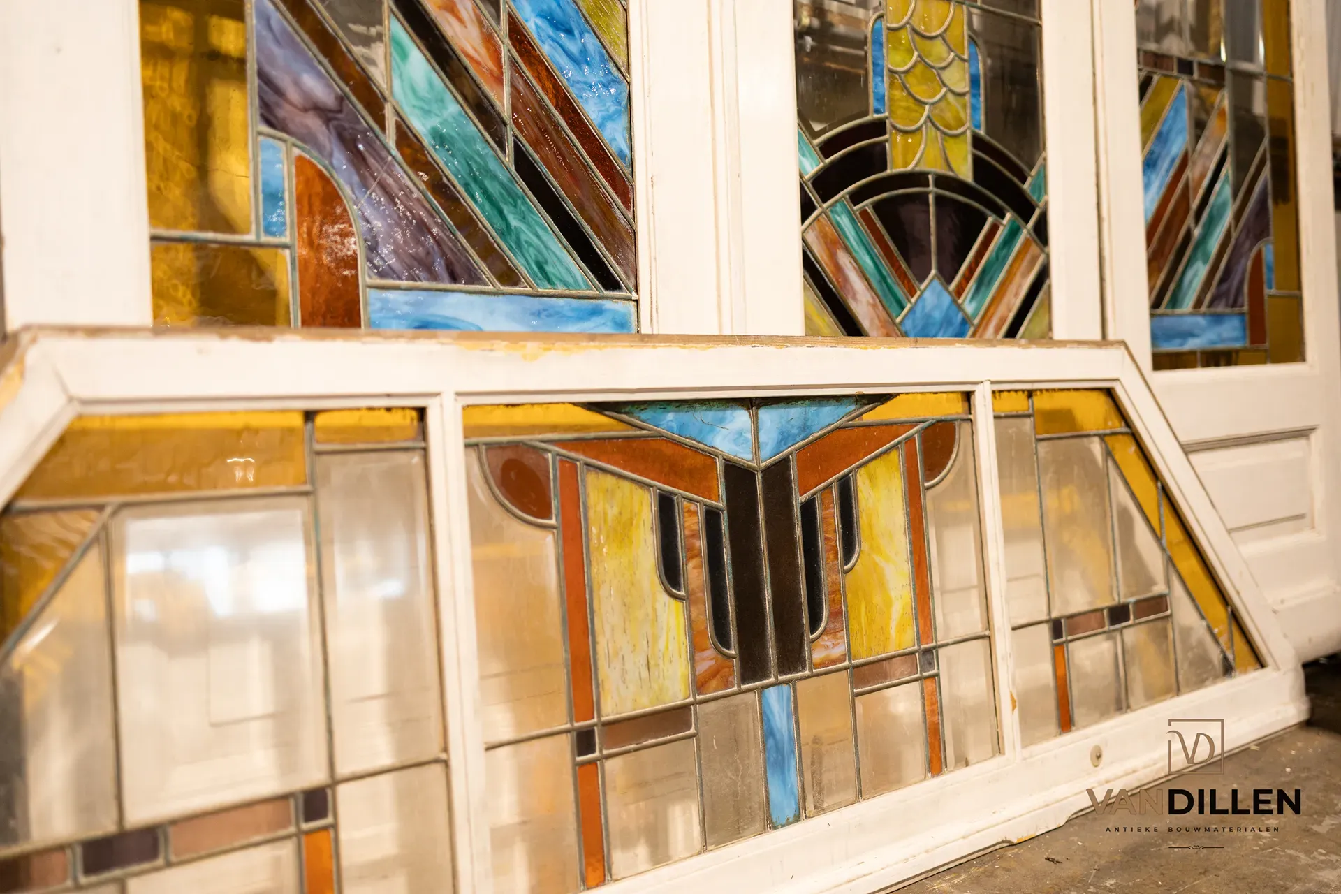 Colourful stained-glass detail in a white door frame