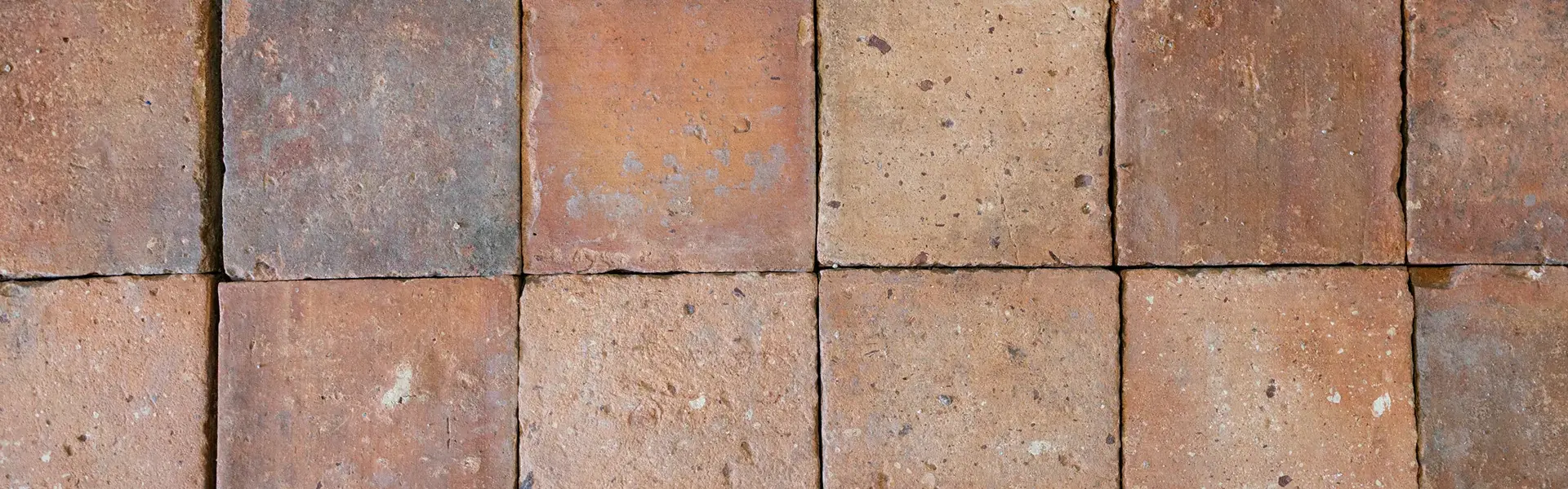 Antique light-coloured terracotta floor tiles in French country style