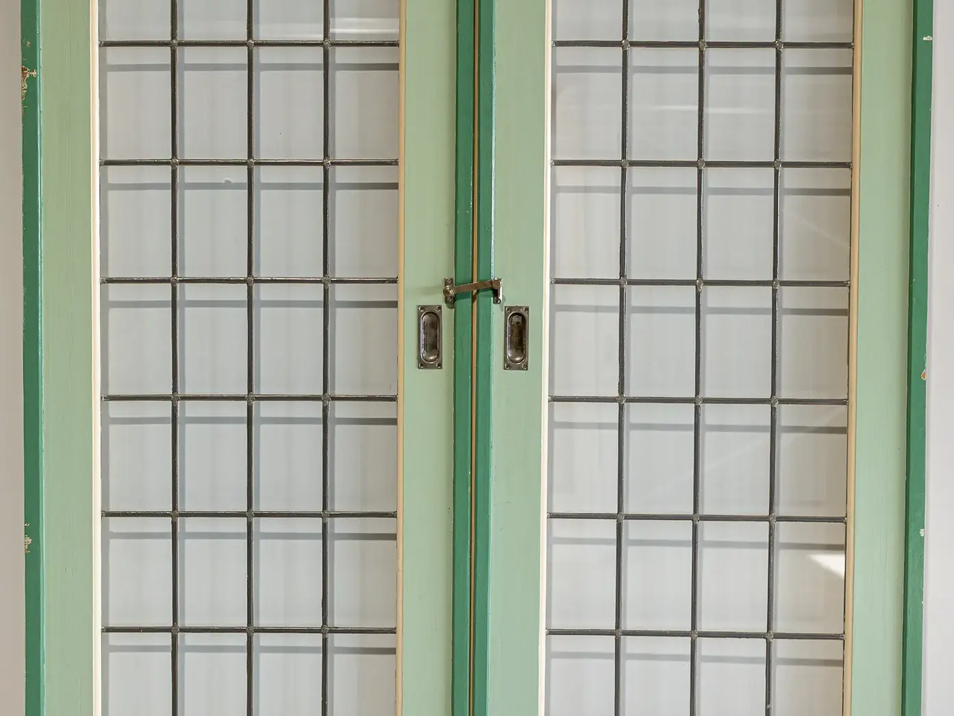 Old internal dividing doors with stained glass