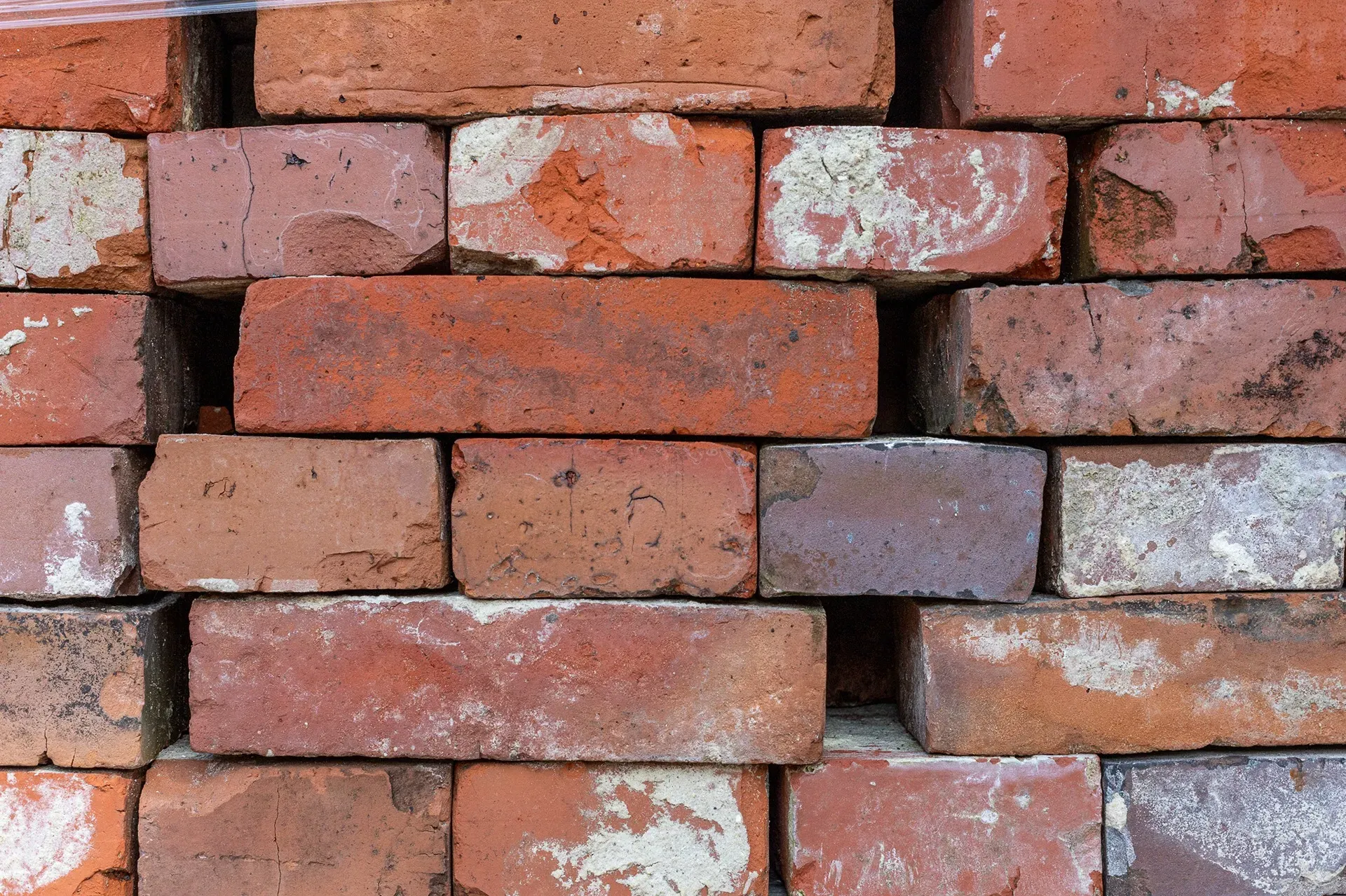 Old red masonry bricks cleaned of mortar